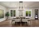 Bright dining room with large windows and modern chandelier at 5302 Pinehurst Dr, Boulder, CO 80301