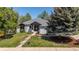 Charming one-story home featuring a landscaped front yard and classic architectural details, with lush trees surrounding the property at 5302 Pinehurst Dr, Boulder, CO 80301