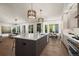 Open kitchen with a large island, stainless appliances, and views to the dining and living areas at 5302 Pinehurst Dr, Boulder, CO 80301