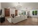 Open-concept living room with hardwood floors, fireplace, and expansive windows, seamlessly connecting to the dining area at 5302 Pinehurst Dr, Boulder, CO 80301