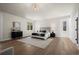 Spacious bedroom with hardwood floors, a decorative rug, and large windows offering natural light at 5302 Pinehurst Dr, Boulder, CO 80301