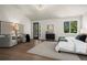 Bright main bedroom with hardwood floors, sitting area, stylish lighting, and access to the outdoors at 5302 Pinehurst Dr, Boulder, CO 80301