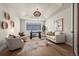 Bright home office with tray ceiling, natural light, stylish furnishings, and hardwood floors, perfect for productivity at 5302 Pinehurst Dr, Boulder, CO 80301