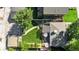 Aerial view of a home with a well-manicured lawn, patio, and mature trees at 2734 King St, Denver, CO 80211