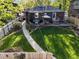 Aerial view of a backyard featuring a deck, lawn, and mature trees at 2734 King St, Denver, CO 80211