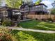 Lush backyard featuring a large lawn, patio with seating, and mature trees at 2734 King St, Denver, CO 80211