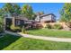 Spacious backyard with lush green lawn, patio with seating, and mature trees at 2734 King St, Denver, CO 80211