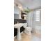 Well-lit bathroom with pedestal sink, glass block window, and shower/tub combination at 2734 King St, Denver, CO 80211
