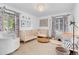 Bright Bedroom with two cribs, patterned curtains, and neutral decor for a calming atmosphere at 2734 King St, Denver, CO 80211