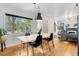 Bright dining area with hardwood floors, modern pendant lighting, and large windows at 2734 King St, Denver, CO 80211