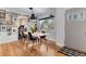 Cozy dining room featuring hardwood floors, modern lighting, and a view of the kitchen at 2734 King St, Denver, CO 80211