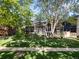 Charming home with mature trees, lush green lawn, and inviting sidewalk at 2734 King St, Denver, CO 80211