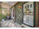 Inviting front porch with a covered trellis, cozy chair, and decorative security door at 2734 King St, Denver, CO 80211