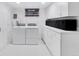 Well-organized laundry room with modern appliances and ample storage cabinets at 2734 King St, Denver, CO 80211