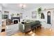Bright living room with hardwood floors, stylish decor, and a modern fireplace at 2734 King St, Denver, CO 80211
