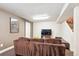 Finished basement with a large sofa, flat screen TV, sliding barn door, and painted accent walls at 8170 E Phillips Cir, Centennial, CO 80112