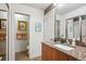 Modern bathroom with granite countertop, wood cabinets, and tile flooring with an adjacent toilet room at 8170 E Phillips Cir, Centennial, CO 80112