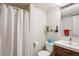Clean and functional bathroom featuring a shower curtain, toilet, and modern sink with wood-look vanity at 8170 E Phillips Cir, Centennial, CO 80112