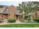 Charming home featuring a brick chimney, well-manicured landscaping, and a welcoming front entrance at 8170 E Phillips Cir, Centennial, CO 80112