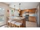 Modern kitchen with an island featuring barstool seating, stainless steel appliances, and sleek wood cabinets at 8170 E Phillips Cir, Centennial, CO 80112