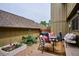 Backyard patio featuring outdoor seating, a grill, and a garden planter with flowers at 8170 E Phillips Cir, Centennial, CO 80112