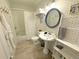 Cozy bathroom featuring stylish vanity, patterned wallpaper, and a charming round mirror at 614 Rose St, Georgetown, CO 80444