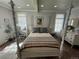 Serene bedroom featuring a four-poster bed, desk area, and hardwood floors at 614 Rose St, Georgetown, CO 80444