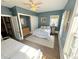 Bright bedroom with blue walls, two white beds, and natural light from the large window at 614 Rose St, Georgetown, CO 80444