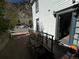 Exterior of home with railing, ramp and a view of street and a wooden bench at 614 Rose St, Georgetown, CO 80444