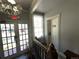 Bright hallway with natural light, vintage details, and elegant staircase at 614 Rose St, Georgetown, CO 80444