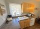 Compact kitchenette with bright wooden cabinets, white appliances, and natural light at 614 Rose St, Georgetown, CO 80444