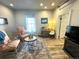 Bright living room with sitting area, area rug, and hardwood floors at 614 Rose St, Georgetown, CO 80444