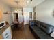A combined living, dining and laundry space with laminate flooring at 614 Rose St, Georgetown, CO 80444