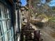 Cozy outdoor patio with street views, stone wall, and shaded seating area at 614 Rose St, Georgetown, CO 80444