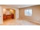 Finished basement with tile flooring, built-in cabinets, and ample natural light at 3644 Rosewalk Cir, Highlands Ranch, CO 80129