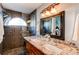 Modern bathroom with dual sinks, granite countertops, and a glass-enclosed shower at 3644 Rosewalk Cir, Highlands Ranch, CO 80129