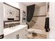 Stylish bathroom featuring a white vanity, modern fixtures, and a shower-tub combination at 3644 Rosewalk Cir, Highlands Ranch, CO 80129