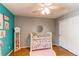 Bright Bedroom featuring hardwood floors, grey and turquoise walls, and white furnishings at 3644 Rosewalk Cir, Highlands Ranch, CO 80129