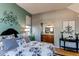 Bedroom with neutral walls, ensuite bathroom, and chic decor at 3644 Rosewalk Cir, Highlands Ranch, CO 80129