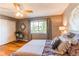 Relaxing bedroom with hardwood floors, a window view, and a spacious closet at 3644 Rosewalk Cir, Highlands Ranch, CO 80129