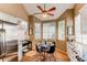 Light-filled breakfast nook with bay windows, charming decor, and stainless refrigerator at 3644 Rosewalk Cir, Highlands Ranch, CO 80129