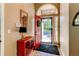 Inviting foyer with a bright red door and classic console table at 3644 Rosewalk Cir, Highlands Ranch, CO 80129