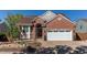 Charming brick home featuring a well-manicured front yard and attached two-car garage at 3644 Rosewalk Cir, Highlands Ranch, CO 80129