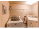 Functional laundry room with a washing machine, dryer, and a wire shelf for storage, perfect for convenience at 3644 Rosewalk Cir, Highlands Ranch, CO 80129