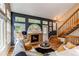 Open-concept living room with hardwood floors, fireplace, and staircase to upper level at 3644 Rosewalk Cir, Highlands Ranch, CO 80129