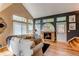 Inviting living room featuring vaulted ceilings, a cozy fireplace, and large windows for natural light at 3644 Rosewalk Cir, Highlands Ranch, CO 80129