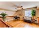 Cozy loft area with hardwood flooring, home office, and sitting area with natural light at 3644 Rosewalk Cir, Highlands Ranch, CO 80129