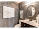 Stylish powder room with a unique vanity, decorative mirror, and elegant wall art at 3644 Rosewalk Cir, Highlands Ranch, CO 80129