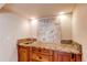 Granite-topped wet bar features custom cabinetry and a stylish decorative painting at 3644 Rosewalk Cir, Highlands Ranch, CO 80129