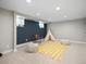Finished basement with carpet, recessed lighting, play tent and bright yellow rug at 9930 W 82Nd Ave, Arvada, CO 80005